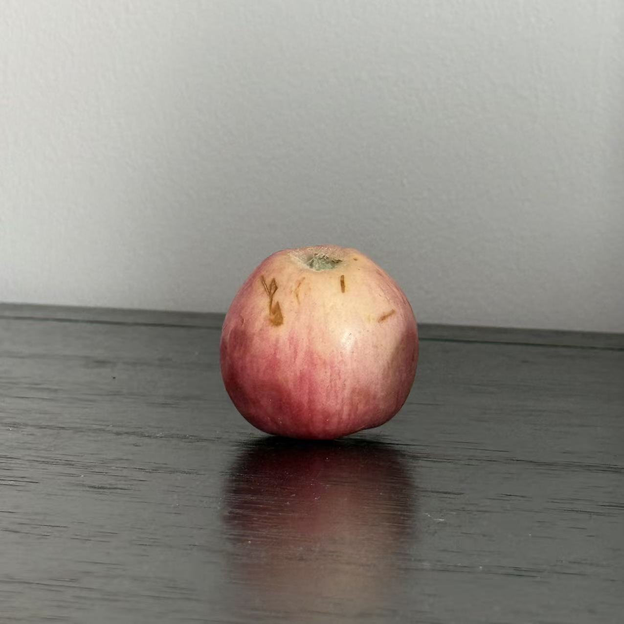 This is an apple in another perspective, its appearance is sphericity,I chose it because it's the closest thing to a sphere in my home and it's obvious at a glance that it's a sphere.